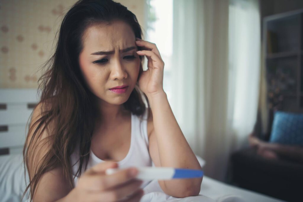 A woman looking at the pregnancy test