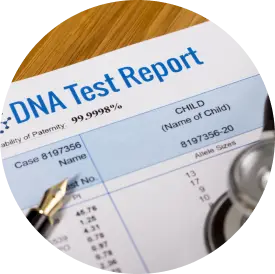 A dna test report indicating a paternity probability of 99.999% with a pen and stethoscope beside it.