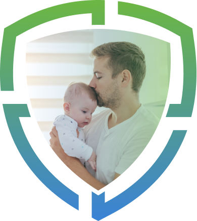 A father affectionately kissing his baby's forehead inside a shield-shaped frame.